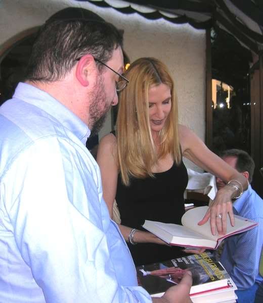 Ann Coulter graciously signing one of Aaron's extensive library