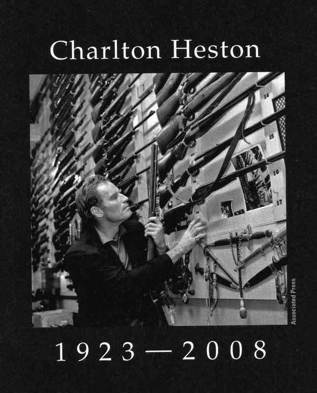 charlton heston gun collection.  Charlton Heston looks over the stock of rifles in the gunshop at 