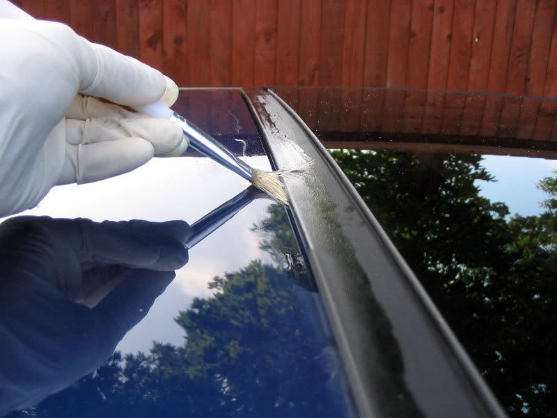Fixing a sunroof leak.